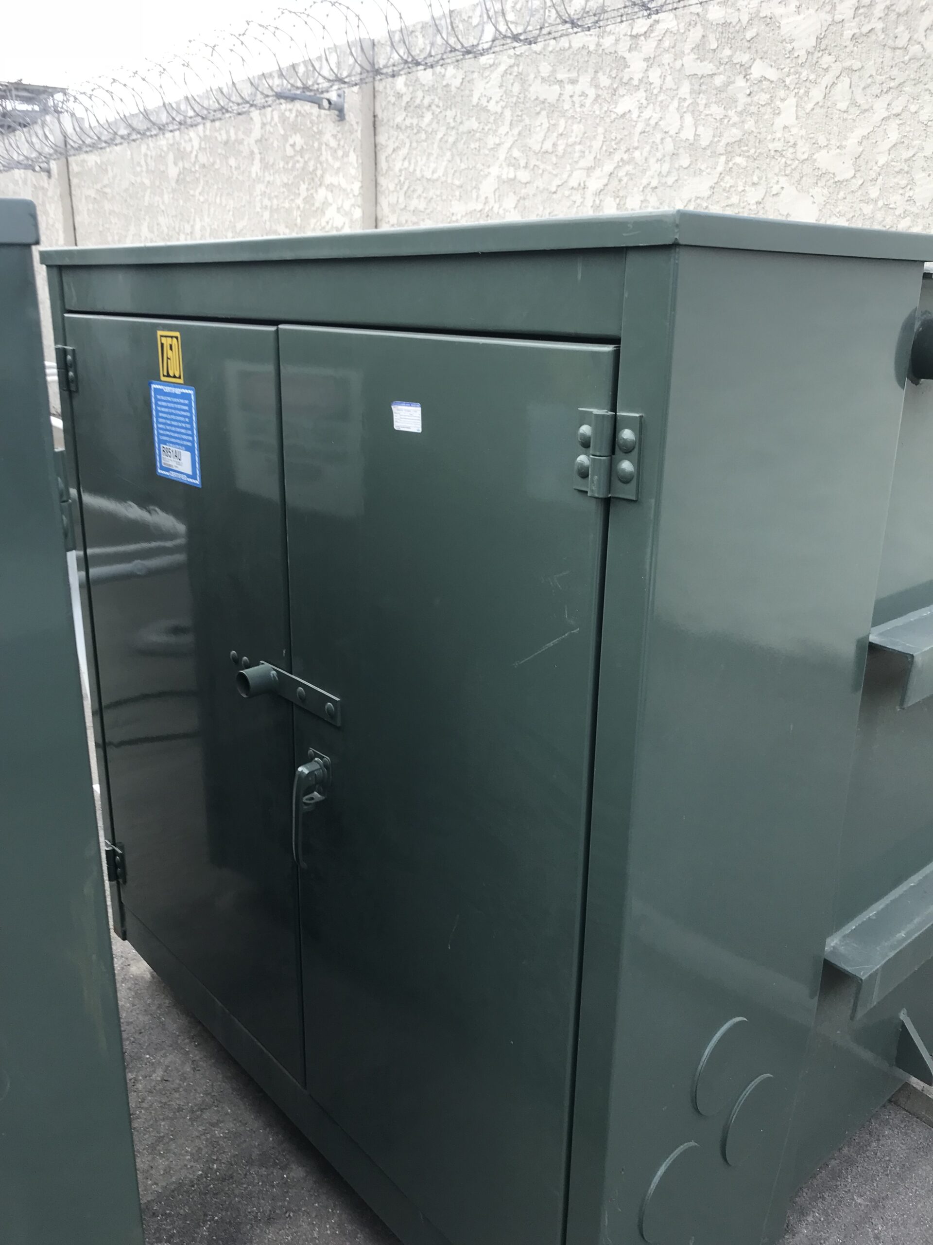 Padmount transformer staged for pickup at a customer site