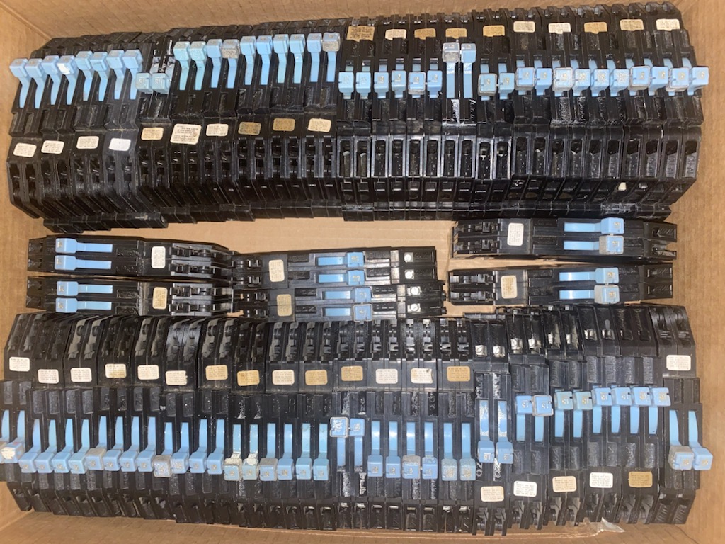 Sorted electrical switches and breakers from a warehouse buyout